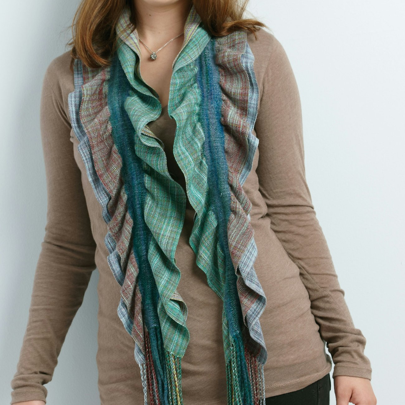 A handwoven scarf with ruffle edges