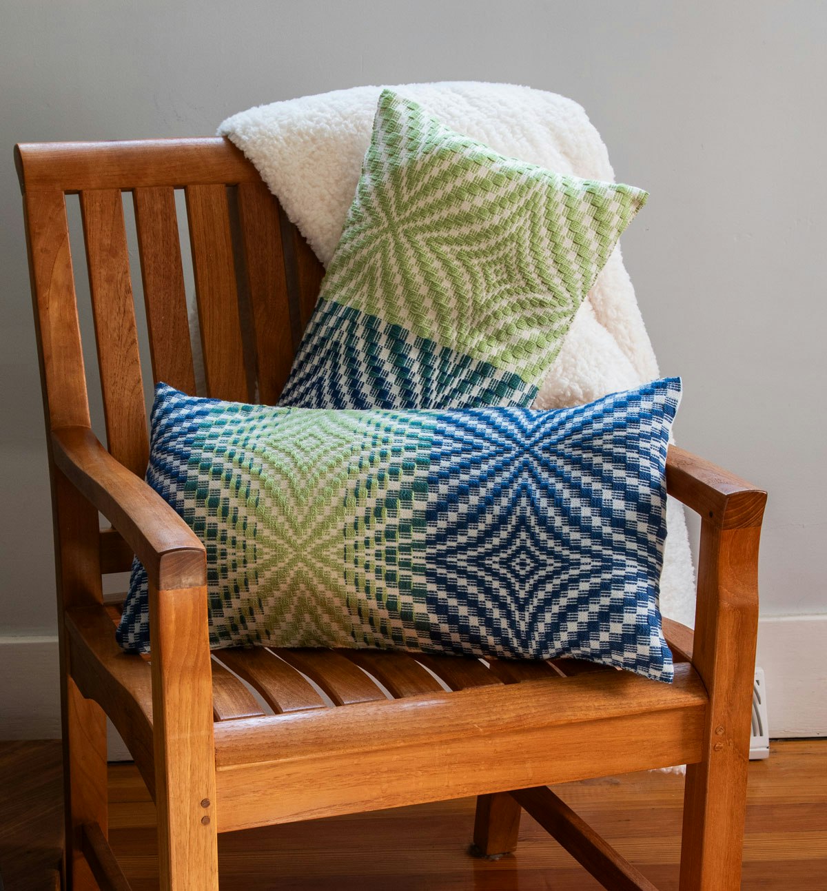 A pair of pillows with blue and green patterning.