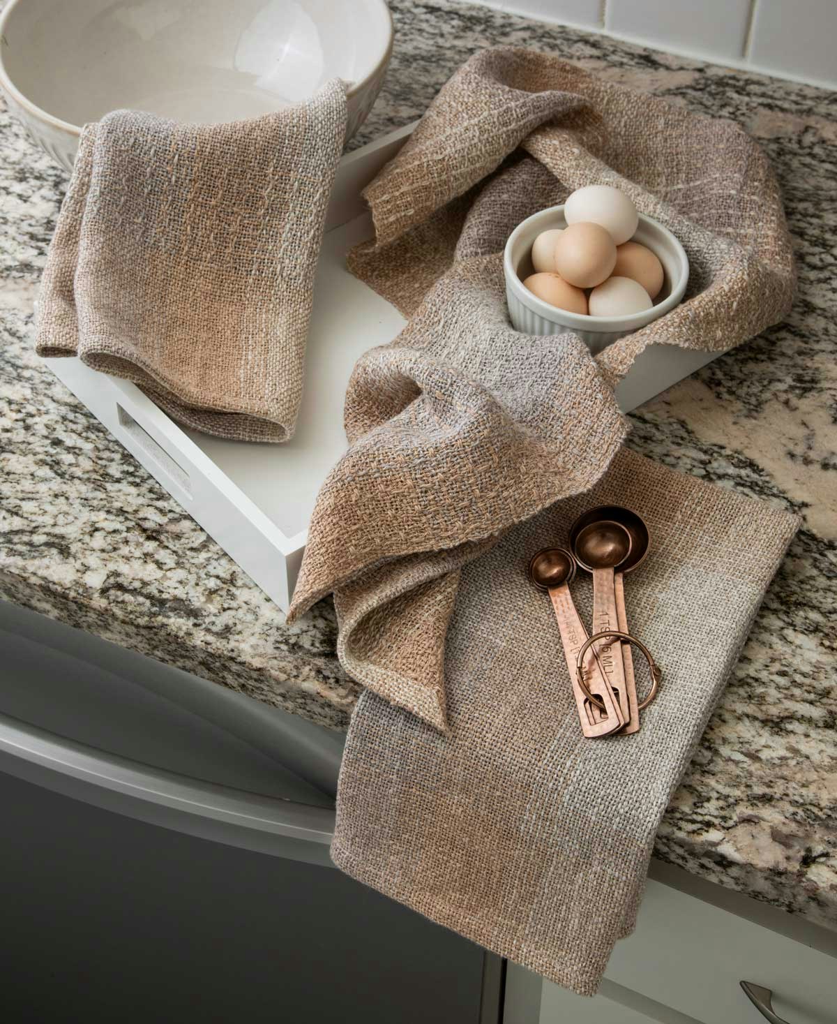 Towels in gentle hues of sand and driftwood.