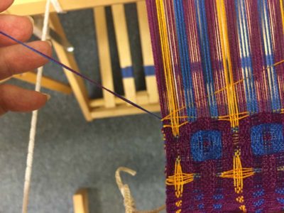 c. Pull gently on both the active and inactive wefts to eliminate any weft loops.